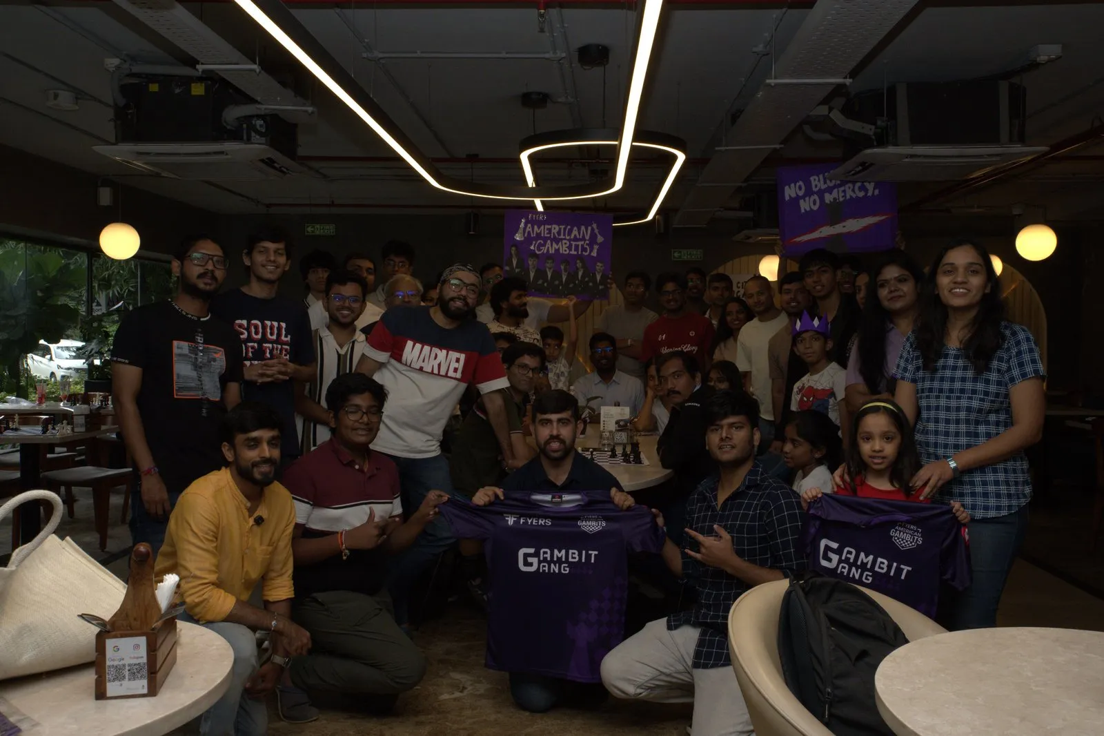 The Gambits Gang at the orientation meetup, holding up supporter jerseys and placards