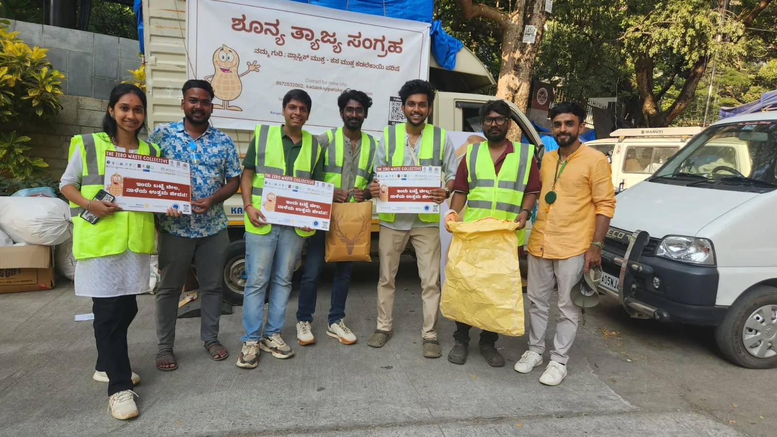 Volunteers in hi-vis vests holding Zero Waste Collective signs at Kadalekayi Parishe, Bangalore