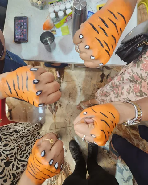 Hands painted with tiger stripes at the World Tiger Day awareness drive